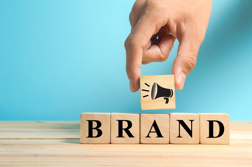 megaphone and BRAND spelling on wooden blocks